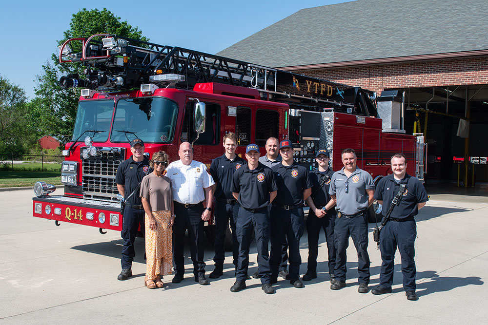 2026 YTFD Firefighters standing with the Q14 Ladder Truck in front of the Main Fire Station