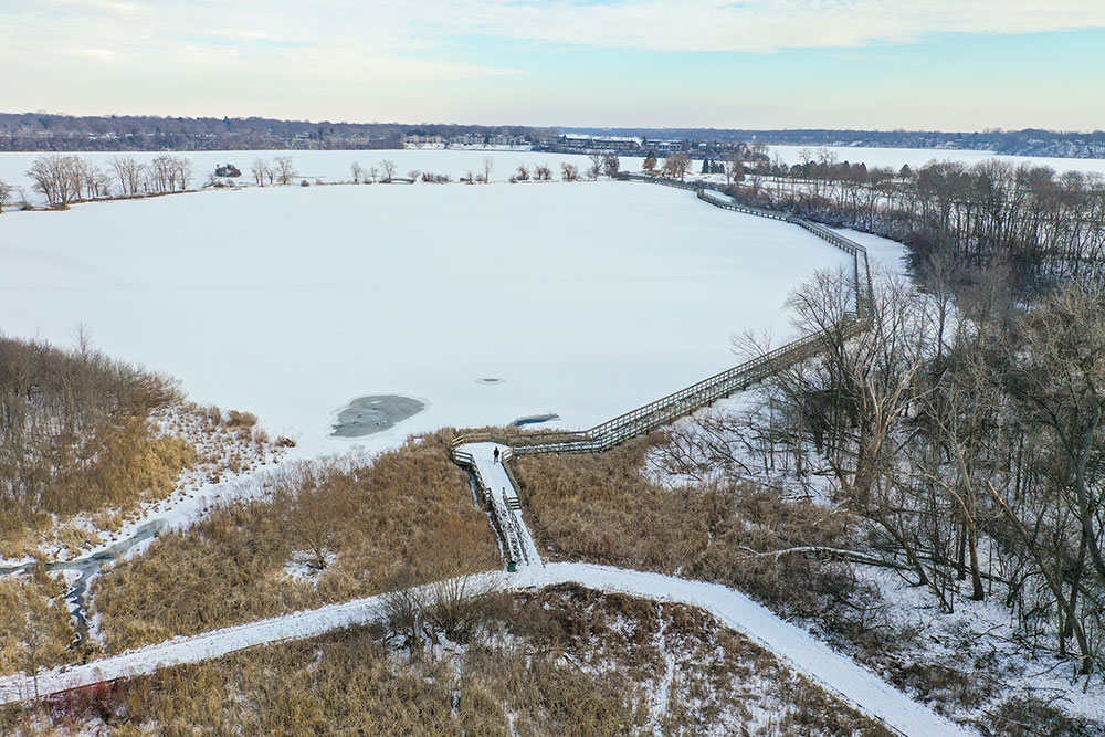 North Bay Park boardwalk aerial view in winter with ice and snow on Ford Lake