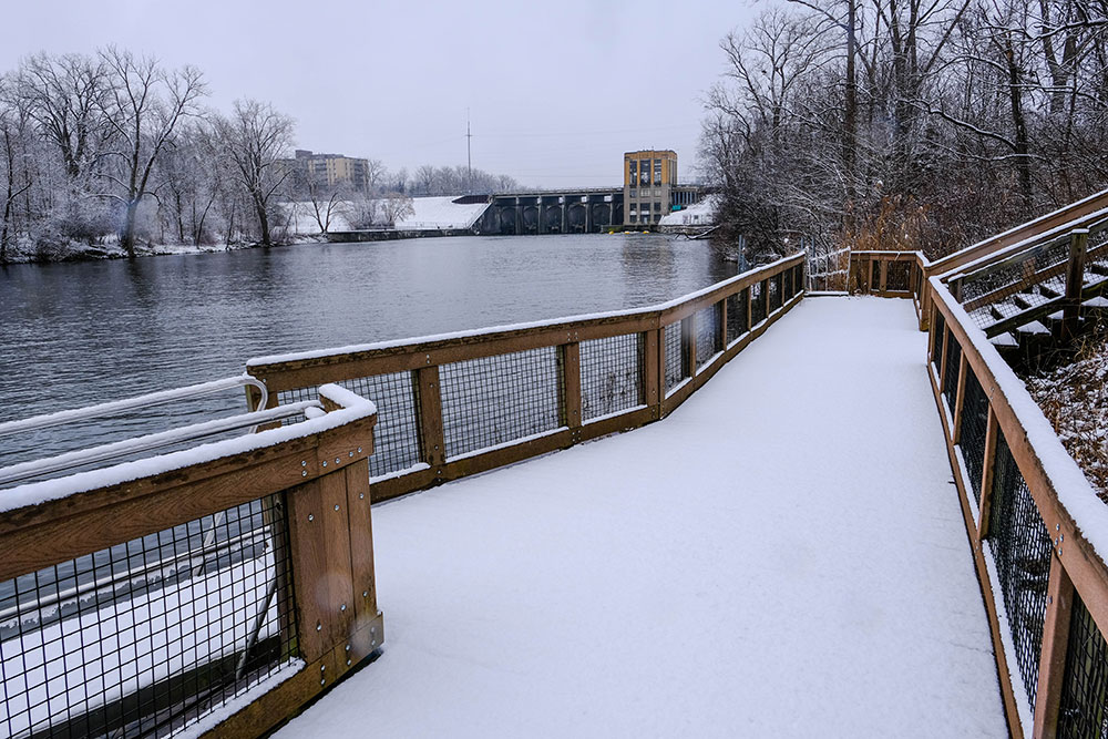 North Hydro Park boardwalk in winter with view of Hydro Dam Station