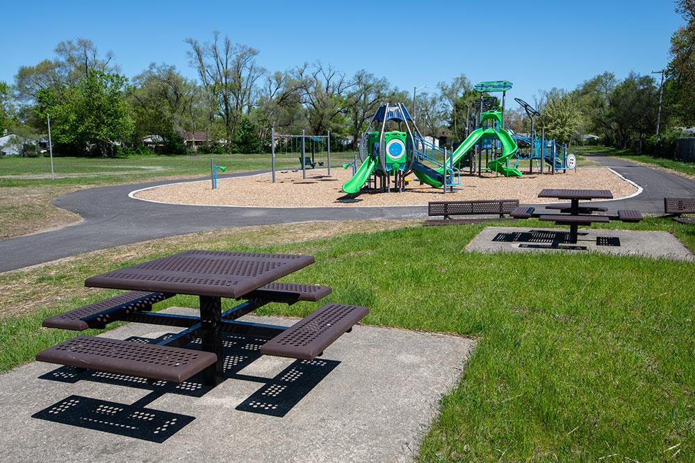 West-Willow Park picnic table with walking path and playground in the distance